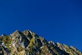 Sharp rocky mountain peaks under deep blue sky in Fagaras Mountains, Romania. View from Transfagarasan Highway. Copy space Royalty Free Stock Photo