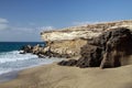 Sharp rugged cliff and rocks on isolated secluded beach at north-west coast of Fuerteventura, Canary Islands, Spain