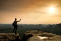 Sharp silhouette of active man on mountain peak