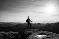 Sharp silhouette of active man on mountain peak