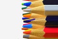 The sharp tips of the pencils. Bright colored pencils. Colored pencils on white background with selective focus. Write