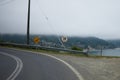 Curve road with speed limit sign before cliff