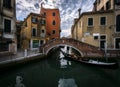 The sharp turns of the Venetian canals. A day in the life of gondoliers. Reflections in sea water. Venice. Italy