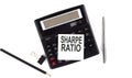 SHARPE RATIO text on sticker on calculator with pen,pencil on white background