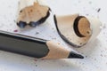 Sharpened black pencil and wood shavings, drawing concept Royalty Free Stock Photo