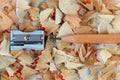 Sharpened brown pencil and sharpener on shavings