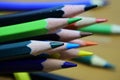 Sharpened color pencil on blurred brown wood table