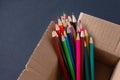 Colored pencils in a cardboard box Royalty Free Stock Photo