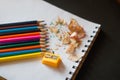 Sharpened colored pencils, sharpener and shavings Royalty Free Stock Photo