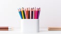 sharpened colored pencils in a white holder against a plain background Royalty Free Stock Photo