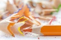 Sharpened colorful orange pencil and wood shavings, drawing concept Royalty Free Stock Photo