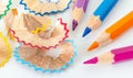 Sharpened colorful pencils and wood shavings, closeup macro Royalty Free Stock Photo