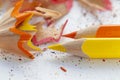 Sharpened colorful yellow and orange pencils and wood shavings, drawing concept Royalty Free Stock Photo