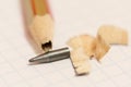 Sharpened pencil with a broken tip over a blank sheet of paper Royalty Free Stock Photo