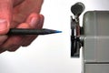 Sharpened pencil close to pencil sharpener Royalty Free Stock Photo