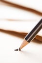 sharpened pencil over a blank old sheet of paper with a broken t Royalty Free Stock Photo