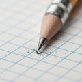 A sharpened pencil rests on graph paper featuring a grid of blue lines Royalty Free Stock Photo