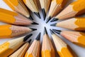 Sharpened pencils arranged in a circular pattern on a white surface, top view Royalty Free Stock Photo