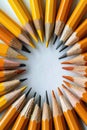 Sharpened pencils arranged in a circular pattern on a white surface, top view Royalty Free Stock Photo