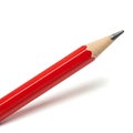 A sharpened red pencil with a pointed tip against a plain background Royalty Free Stock Photo