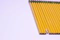 Angle of sharpened pencil in line of unsharpened pencils on white background with copy space Royalty Free Stock Photo