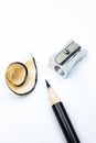 Sharpener and a broken pencil. Shavings and a graphite on white background. Close up, Macro photo Royalty Free Stock Photo