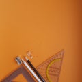 sharpener for color pencils, pencils on an orange background ready for work, flat photography