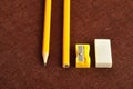 A sharpener, eraser and two yellow pencil