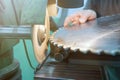Sharpening Circular Saw, worker sharpens a circular saw blade Royalty Free Stock Photo
