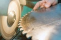 Sharpening Circular Saw, worker sharpens a circular saw blade