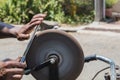 Sharpening a glossy kitchen knife on water stone in India