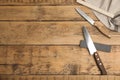 Sharpening stones and knives on wooden table, flat lay. Space for text