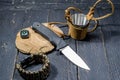 The sharpest knife of a hunter. A compass and a metal mug.