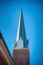 A sharply pointed church steeple against a clear blue sky. Royalty Free Stock Photo