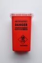 Sharps container for used syringe on white background, top view