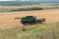 Combined harvester rides on the field during harvesting