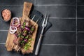 Shashlik grilled meat skewers, shish kebab with beef and lamb meat, onion and herbs. Black background. Top view. Copy Royalty Free Stock Photo