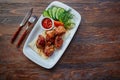 Shashlik, meat cooked on skewers on an open table, in a white plate on a wooden background Royalty Free Stock Photo