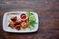 Shashlik, meat cooked on skewers on an open table, in a white plate on a wooden background Royalty Free Stock Photo