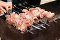 Shashlik, meat grilling on metal skewer, close up