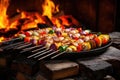 shashlik skewers with colorful vegetables over open fire