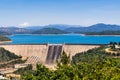 Shasta Dam on a sunny day; the summit of Mt Shasta covered in snow visible in the background; Northern California Royalty Free Stock Photo