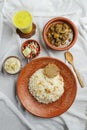 Shatkora Beef kacchi biryani khichuri with salad, borhani and Chui Pitha served in dish isolated on mat top view of indian and Royalty Free Stock Photo