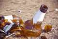 Shattered beer bottle resting on the ground: alcoholism concept Royalty Free Stock Photo
