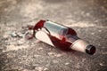 Shattered brown beer bottle resting on the ground Royalty Free Stock Photo