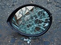 shattered car mirror on dark asphalt, a symbol of damage Royalty Free Stock Photo