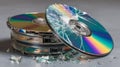 Shattered compact disc and broken pieces on grey background symbolizing data loss, digital destruction, and information failure Royalty Free Stock Photo