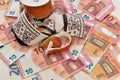 Shattered cup on top of euro bills symbolising economic fallout. Royalty Free Stock Photo