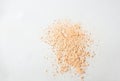 Shattered face powder on white background. Make up powder texture close up. Scattered matte powder