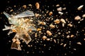 Shattered glass and crumbling stone fragments exploding on black background, destruction concept. Royalty Free Stock Photo